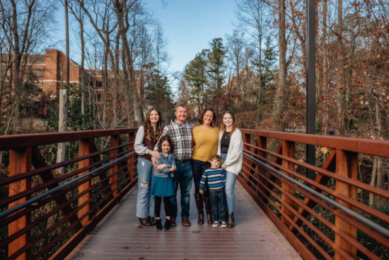Family standing on bridge